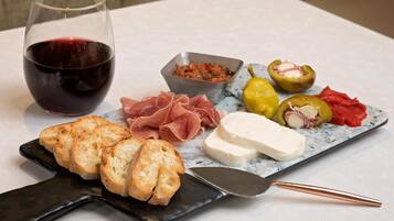 A charcuterie board with bread, cheese, and cured meats.