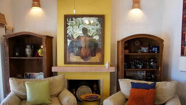 A living room with two sofas, a fireplace, and decorative shelves. - Caracol Peninsula 544 A 2 Bedroom Apartment By Seaside San Carlos (San Carlos)