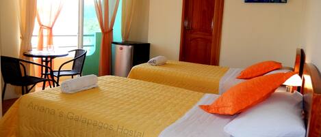 A hotel room with two beds, a TV, a desk, and a chair.