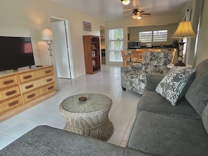 Waterfront King Suite with Balcony | Living area | 43-inch Smart TV with digital channels, TV, streaming services - The Frederiksted Hotel (Frederiksted)