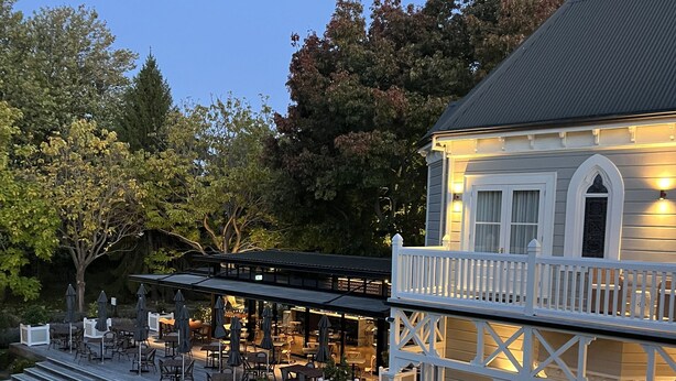A two-story building with a balcony, outdoor seating area, and a well-maintained garden. - The Marlborough (Rapaura)