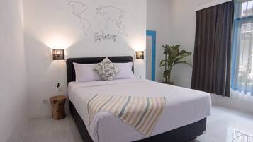 Une chambre à coucher bien rangée, avec un lit, une carte du monde accrochée au mur et une fenêtre avec des rideaux.