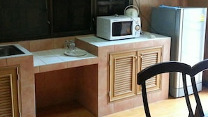 A compact kitchen with a microwave on the counter, a sink, and a refrigerator. - Maesai Doi View Resort (Mae Sai)