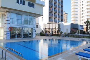 Seasonal outdoor pool, pool umbrellas, sun loungers