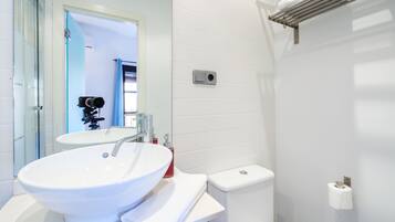 Ein modernes Badezimmer mit Waschbecken, Spiegel und Toilette.