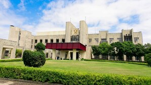 A large, historic building with a prominent entrance, a red overhang, and a well-maintained lawn. - Nanki Shirahama Resort Hotel (Kamitonda)