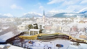 A town with a prominent church, a ski slope, and snow-covered buildings. - Chaletdorf Fanningberg (Weisspriach)