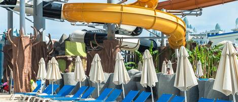 A water park with multiple slides and lounge chairs.