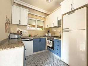Villa | Private kitchen | Full-sized fridge, microwave, oven, stovetop