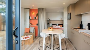 A compact, modern apartment with a kitchen, dining area, and a bedroom. - Les Mûriers (Vendres)