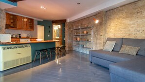 A modern kitchen with wooden cabinets, a built-in stove, and a bar area. - Bubuflats Mossen (Valencia)