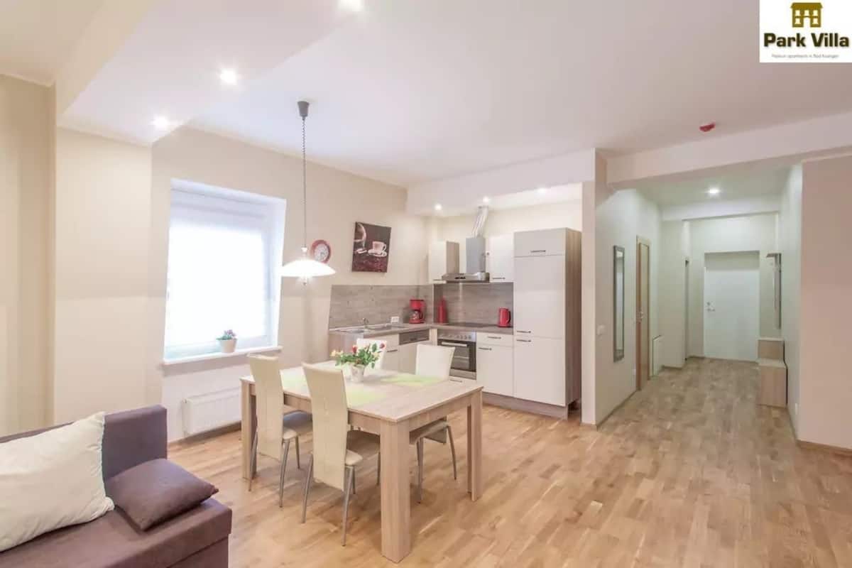 Een modern appartement met een eethoek, kitchenette en woonkamer.