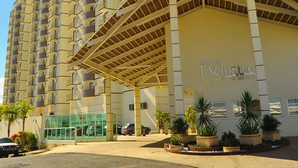 A multi-story hotel with a prominent entrance and a covered area.