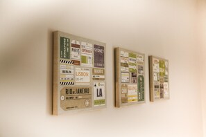 A wall with multiple travel-themed posters, each featuring city names and airport codes.