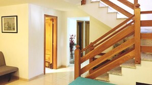 Una escalera con barandillas de madera que sube a un piso superior.