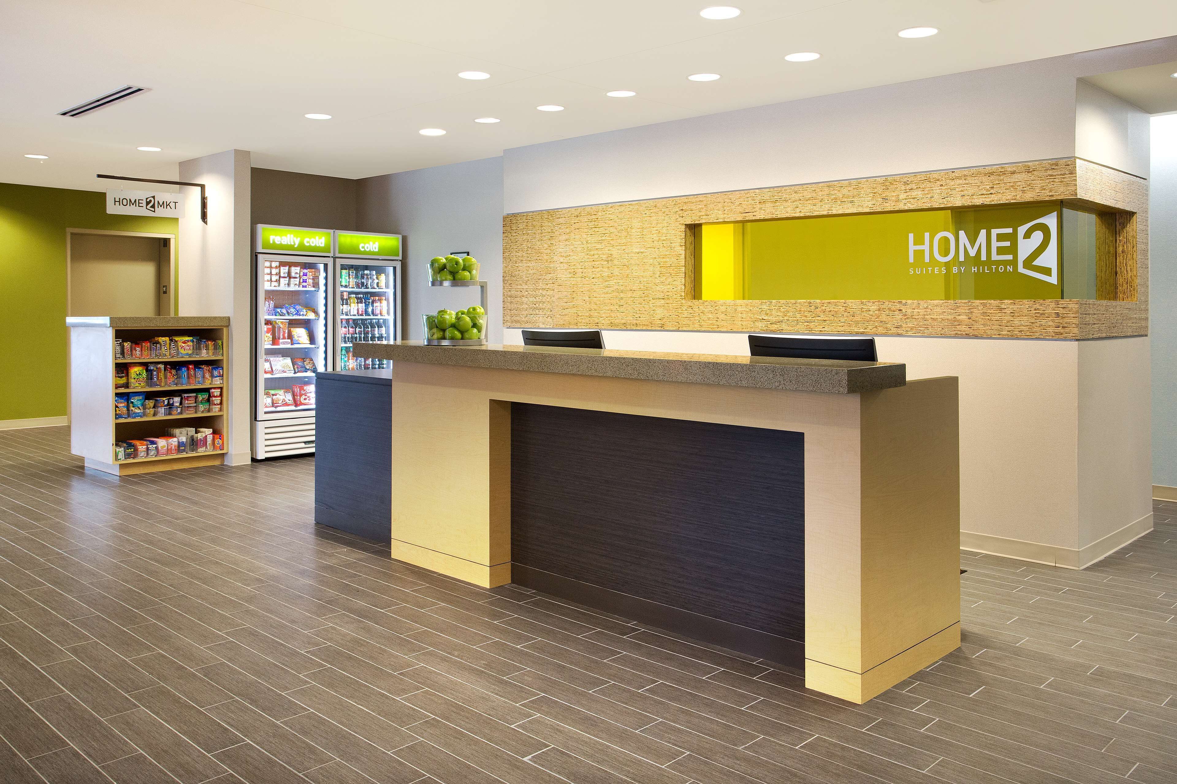 A reception area with a reception desk, a vending machine, and a self-service kiosk.