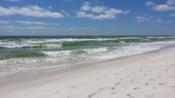 A beach with waves and a clear sky. - 209 Mariner West (Panama City Beach)