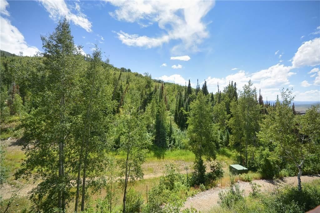 A forested landscape with a clear sky.