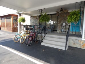 A building with a stone facade, a blue door, and a staircase leading to the entrance.