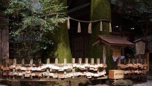 A traditional Japanese shrine with wooden structures, a rope barrier, and stone lanterns. - APA Hotel Miyazaki Nobeoka Chuo (Nobeoka)