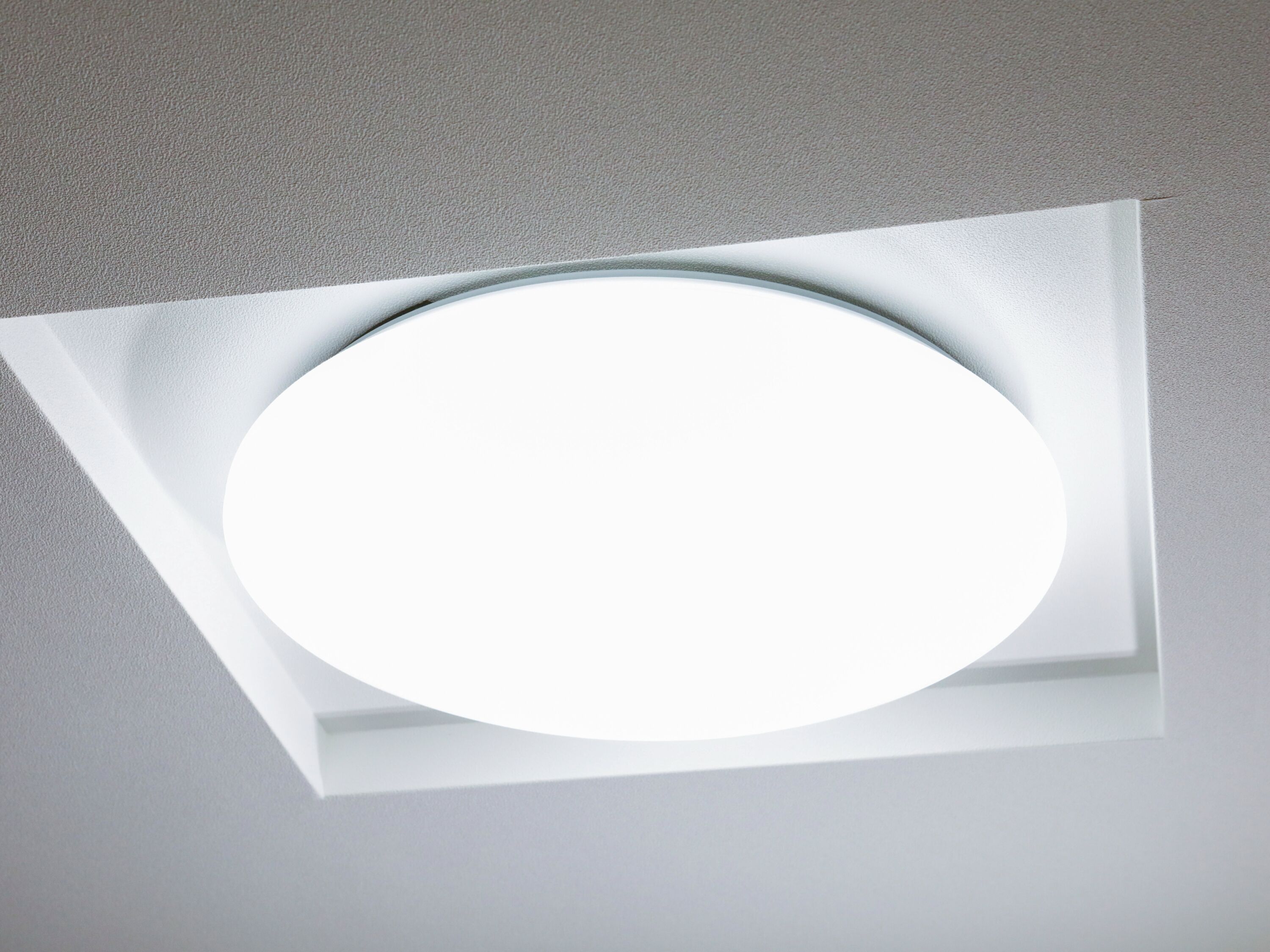 A recessed ceiling light fixture with a circular design.