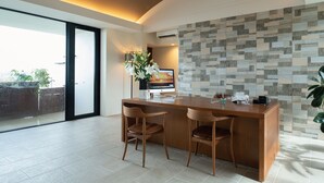 A modern kitchen with a wooden island, two chairs, and a large window. - Condominium T-Room (Yomitan)