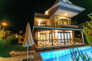 A two-story house with a swimming pool, outdoor seating, and a covered patio area. - Paradise Town Villa Lisa (Serik)
