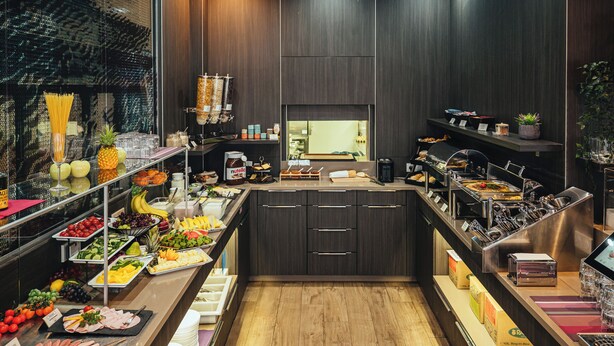 A buffet with various food items and a coffee station.