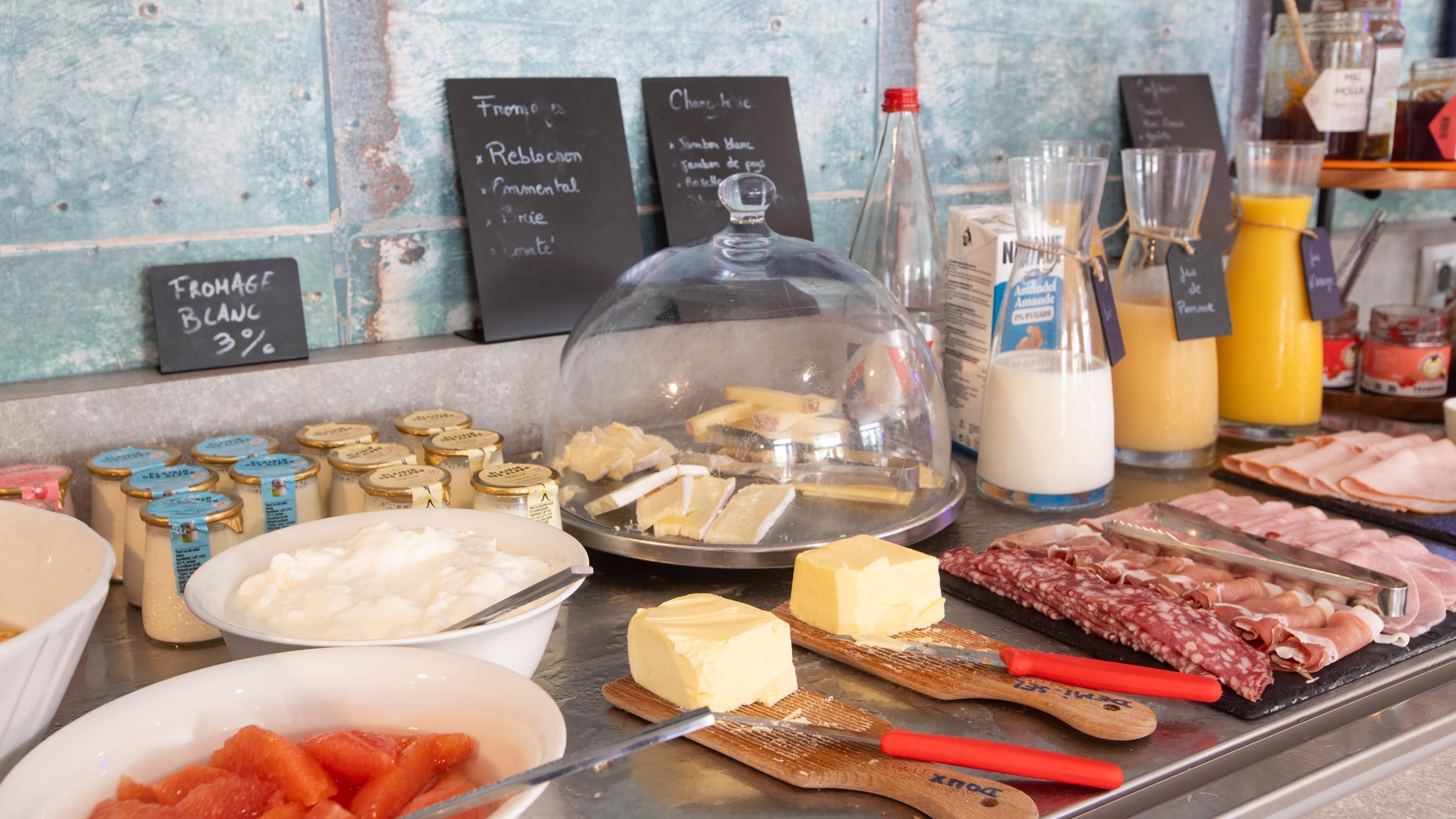A breakfast buffet with various food items and condiments.