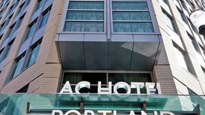 A tall hotel building with a modern design, featuring a prominent sign that reads "AC HOTEL PORTLAND". - AC Hotel by Marriott Portland Downtown, OR (Portland)