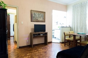 Comfort Triple Room, 1 Bedroom, Refrigerator, City View | Living room | Flat-screen TV