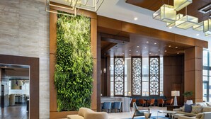 A modern lobby with a vertical garden, seating area, and a bar. - The Westin Sarasota (Sarasota)