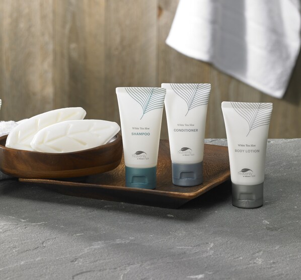 Three White Tea Aloe body care products on a wooden tray.