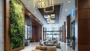 A modern lobby with a vertical garden, comfortable seating, and a geometric light fixture. - The Westin Sarasota (Sarasota)