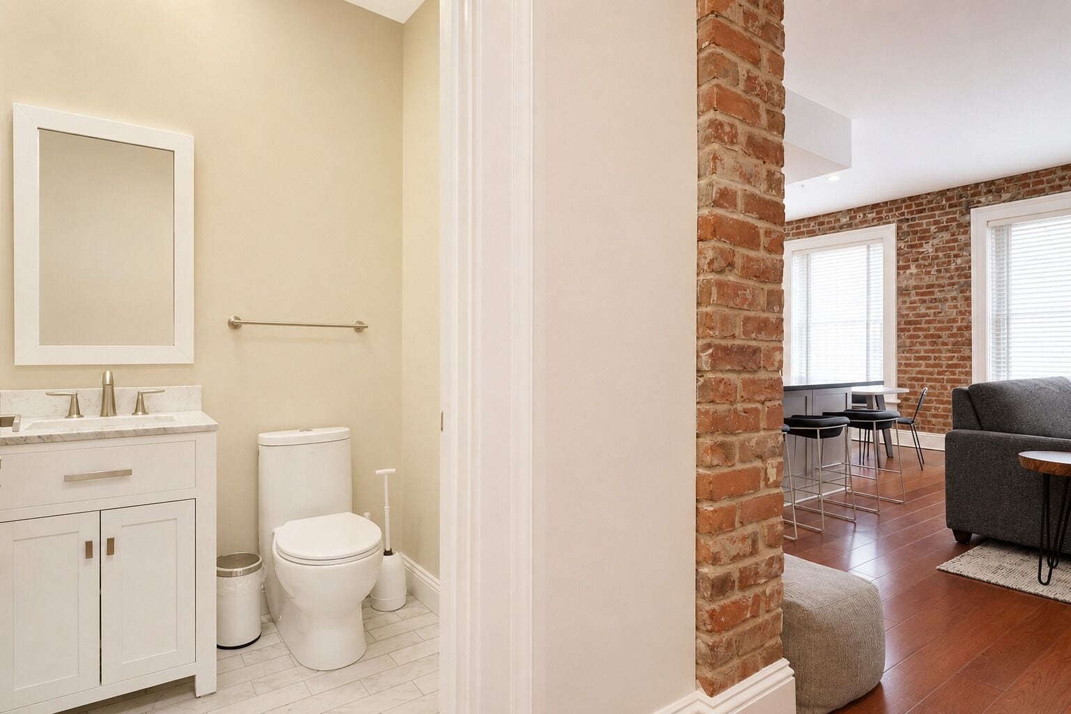 A modern bathroom with a toilet, sink, and mirror.