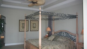 A four-poster bed with a canopy, a ceiling fan, and framed artwork on the wall. - 431 Edgewater Ct (Marco Island)