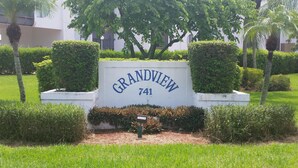 A sign for Grandview, number 741, surrounded by well-maintained hedges and trees. - Grandview 310 (Marco Island)