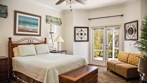 A bedroom with a bed, dresser, nightstand, and a sofa. - 1372 Leland Way (Marco Island)