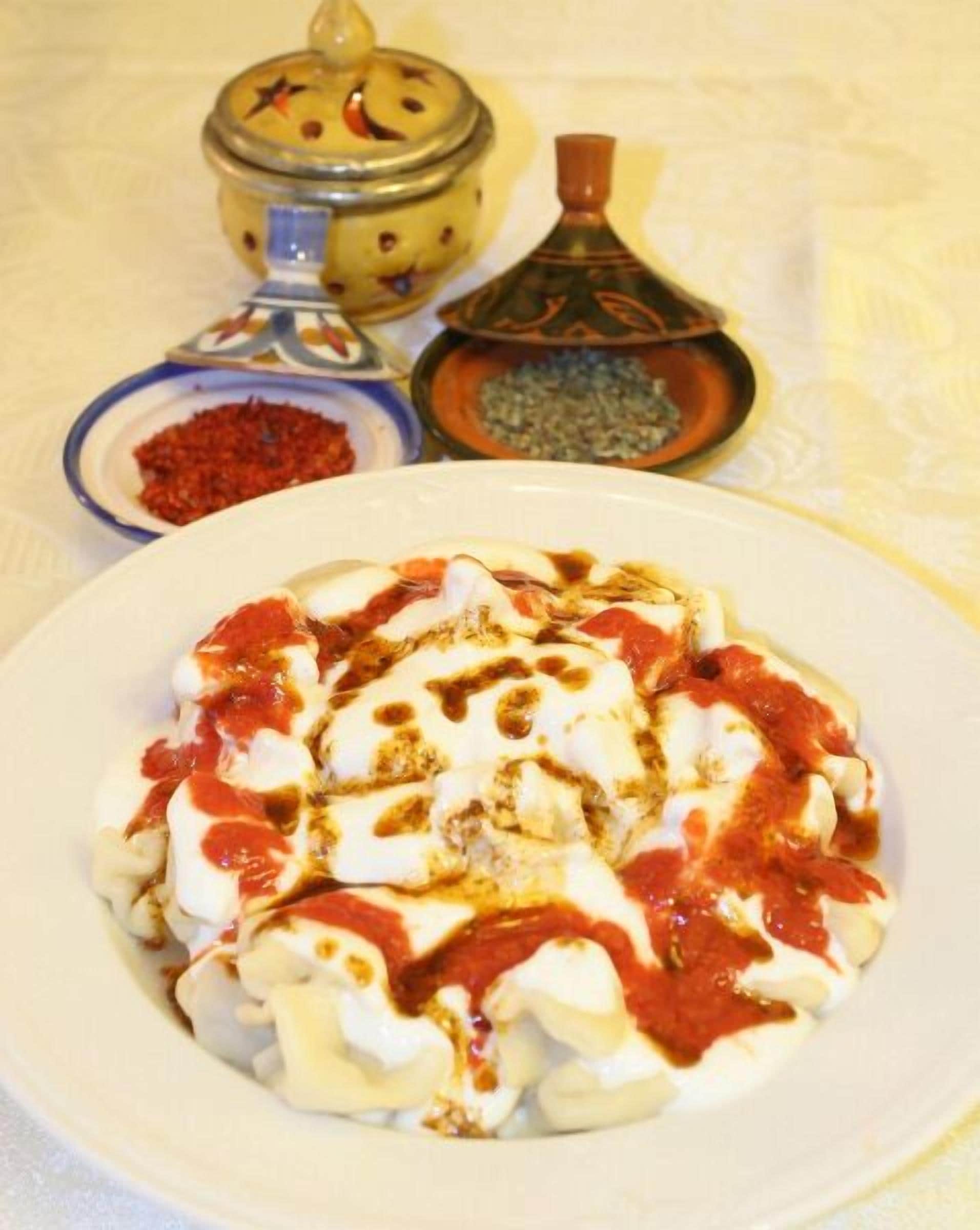 A plate of food with a dollop of sauce on top.