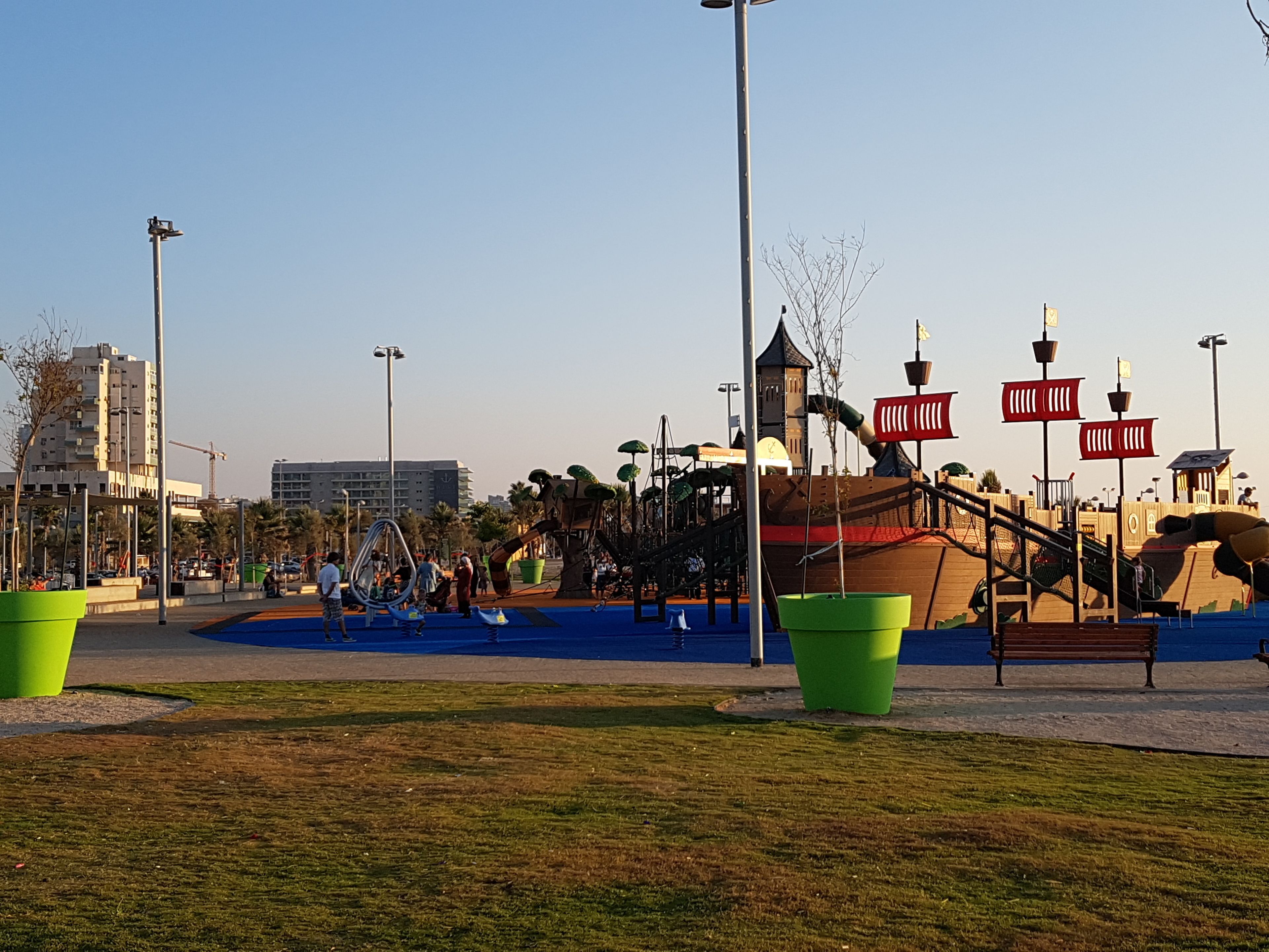 A playground with slides, swings, and a climbing structure.