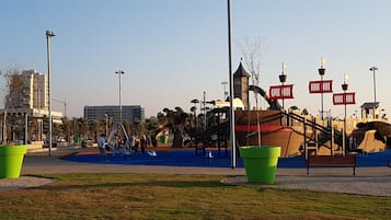 A playground with slides, swings, and a climbing structure.