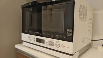 A Toshiba microwave oven on a white countertop.