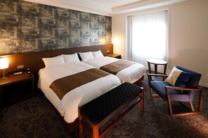 A hotel room with two beds, a desk, a chair, a small table, and a large abstract wall art piece. - Hotel New Omi (Omihachiman)
