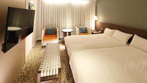 A hotel room with a large bed, two armchairs, a small table, and a TV. - Hotel New Omi (Omihachiman)