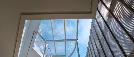 A staircase with metal railings and a clear view of the sky above.