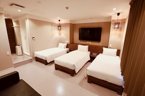 A hotel room with three single beds, a large flat-screen TV, and a wooden headboard. - Hotel 88 Shinsaibashi (Osaka)