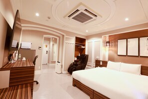 A hotel room with a large bed, a desk, a massage chair, and a walk-in closet. - Hotel 88 Shinsaibashi (Osaka)