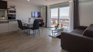 Deluxe Apartment, 2 Bedrooms, Balcony, Sea View | Living area | Flat-screen TV