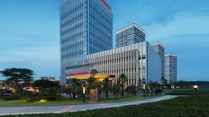 A modern hotel with a prominent vertical design and a large entrance canopy.