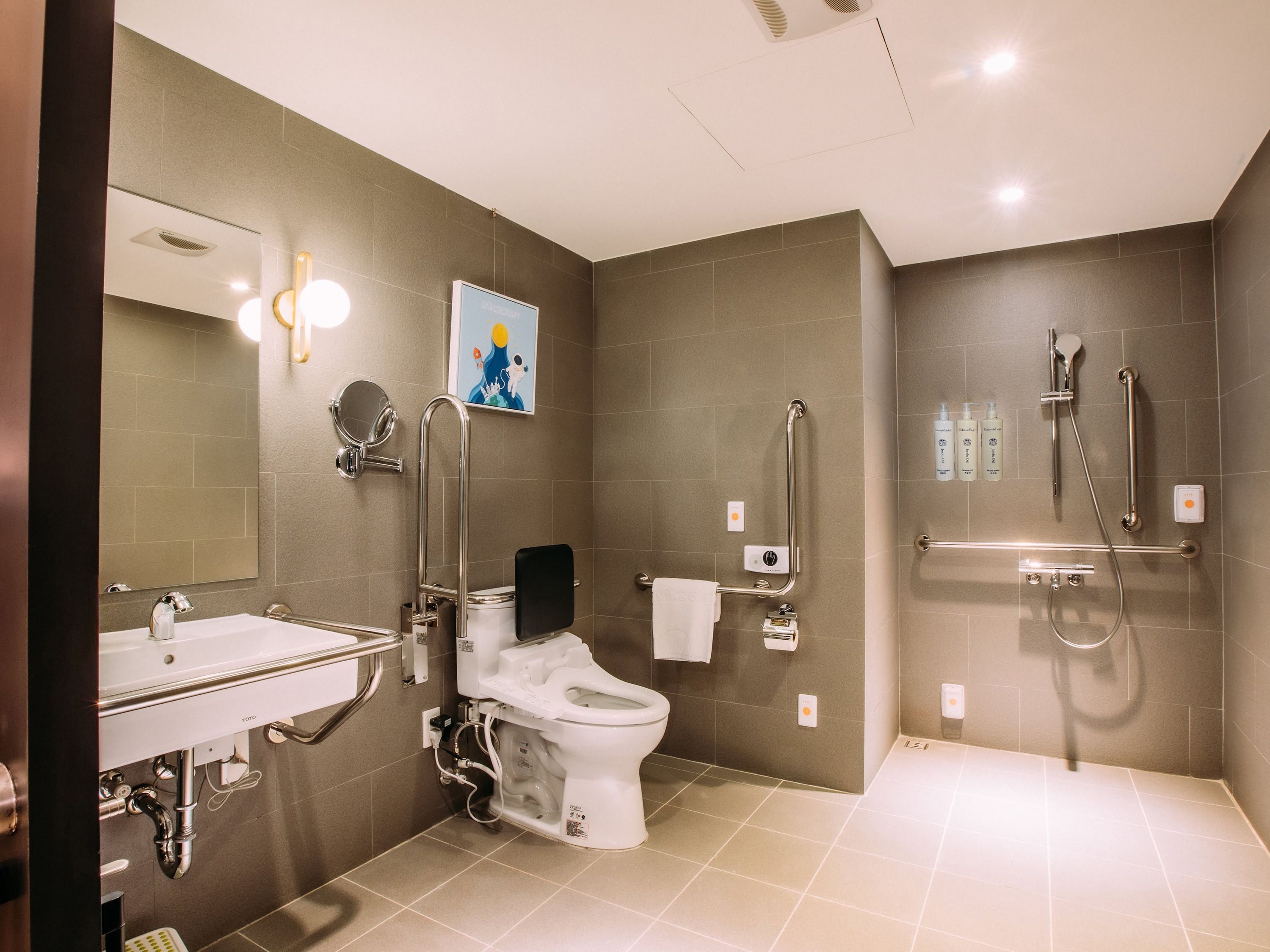 A modern bathroom with a toilet, bidet, and shower.